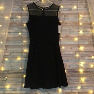 Unworn, black cocktail dress with lace neckline